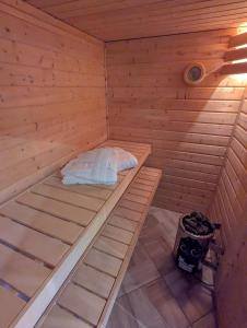 a wooden sauna with a bed in the middle at Wellness Minikvítek in Smržovka