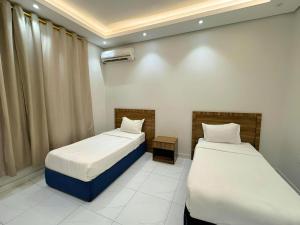 Postel nebo postele na pokoji v ubytování نوفل للشقق المخدومة