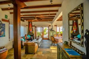 a living room with a person sitting on a couch at Casa Baronesa Waterfront Villa in Puerto Villamil