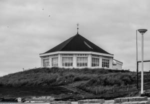 a building on top of a hill with a street light at Alte Teestube 55 in Norderney