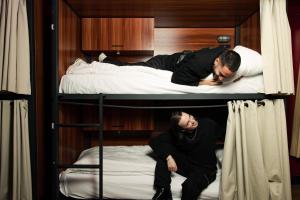 two men sitting on top of bunk beds at Malacuna Manchester in Manchester +68 photos