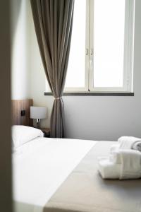 Ένα ή περισσότερα κρεβάτια σε δωμάτιο στο Casa per Ferie Santa Maria alle Fornaci