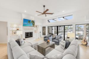 a living room with a couch and a table at Coastal waterfront home with pool spa and dock in Rookery Island