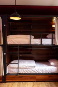 a room with three bunk beds in a room at Malacuna Manchester in Manchester