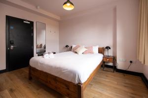 a bedroom with a bed with two towels on it at Malacuna Manchester in Manchester