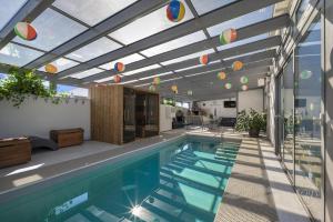 an indoor swimming pool with a ceiling with colorful lights at SPA vila na Golfe in Hrubá Borša