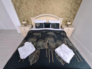 a bedroom with a bed with two towels on it at SPA vila na Golfe in Hrubá Borša +44 photos