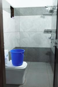 a bucket sitting on top of a toilet in a bathroom at Guest arc Residency in Sultan Bathery