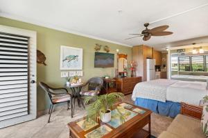 a bedroom with a bed and a table in a room at Napili Bay 210 · NB 210 Napili Bay Studio with Direct Ocean View in Kahana