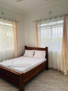 Ένα ή περισσότερα κρεβάτια σε δωμάτιο στο Faida general enterprises