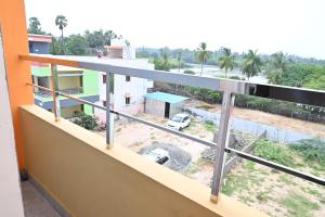 a balcony with a view of a house at Gugan home stay in Tiruchchendūr +15 photos