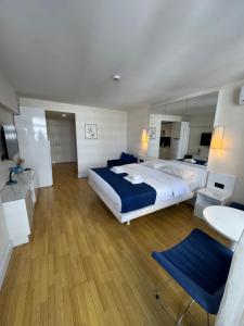 a bedroom with a large bed and a large mirror at Orbi city batumi new in Batumi