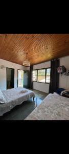 Ένα ή περισσότερα κρεβάτια σε δωμάτιο στο Quartos Sierra Tiradentes