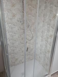 a shower stall with a glass door with a shower at Il Piccolo Borgo sul Lago in Rome