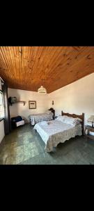 Ένα ή περισσότερα κρεβάτια σε δωμάτιο στο Quartos Sierra Tiradentes