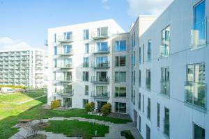 un edificio de apartamentos con jardín frente a él en Spacious 2-BR w a balcony by Odense harbour - 93, en Odense