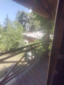 a view of a deck from a window of a house at Cabañas L' armonie in Bialet Massé