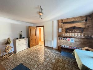 a room with a bed and a dresser and a door at Apartment Tirol #Spielanger Hof# in Weer