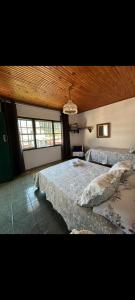 Ένα ή περισσότερα κρεβάτια σε δωμάτιο στο Quartos Sierra Tiradentes