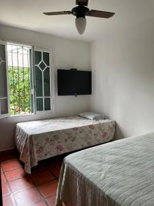 Postel nebo postele na pokoji v ubytování Casa da Árvore Bertioga