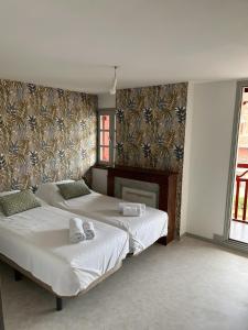 Ένα ή περισσότερα κρεβάτια σε δωμάτιο στο Les dames de Salies