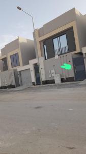 a green frisbee in the air in front of a building at المعتلية in Riyadh
