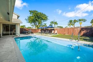 a swimming pool in the backyard of a house at Spacious 6BR Beach Getaway w Heated Pool in Barwal