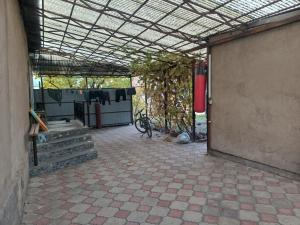 an outdoor area with a building with a patio at CenterHouse1 in Karakol