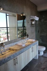 a bathroom with a sink and a toilet at Penthouse with Glass Floor and Volcano View in Cholula +80 photos