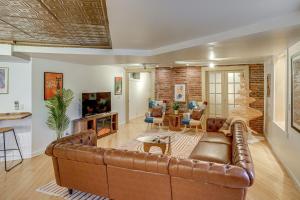 a living room with a brown leather couch at Walk to Athens Riverfront Park! Modern-Retro Apt in Athens