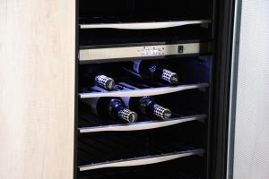 a wine rack with bottles of wine in it at Penthouse with Glass Floor and Volcano View in Cholula
