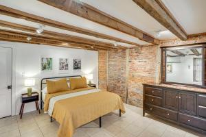 a bedroom with a bed and a dresser and a mirror at Walk to Athens Riverfront Park! Modern-Retro Apt in Athens