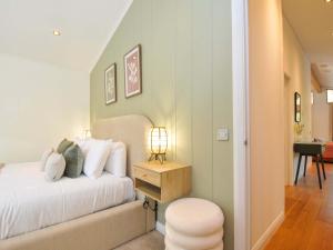 a bedroom with a bed and a table with a lamp at 6 Stonerush Valley in Looe