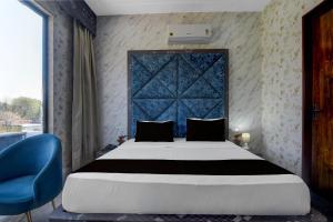 Postel nebo postele na pokoji v ubytování Hotel O RG PALACE HOTEL