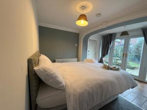 a bedroom with a large bed with a window at room 02 chesterton Grove in Manchester