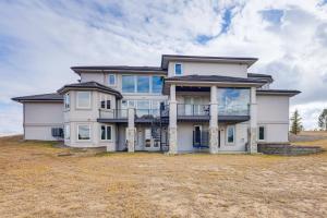 a large house on a grassy field at Spacious Southern Colorado Home with Mountain Views in Monument