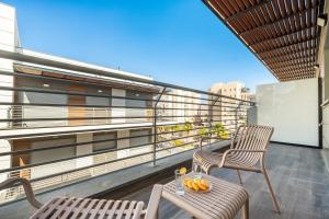 un balcon avec deux chaises et une table sur un immeuble dans l'établissement Modern Eilat Escape with Heated Pool, à Eilat