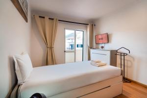 Ένα ή περισσότερα κρεβάτια σε δωμάτιο στο GuestReady - Machico Apartment with Balcony