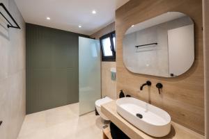 a bathroom with a sink and a mirror at Paizan Homes - Kos City Center Apartments in Kos