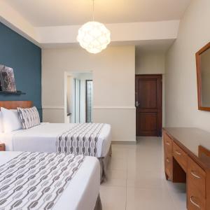 Ένα ή περισσότερα κρεβάτια σε δωμάτιο στο Hodelpa Caribe Colonial