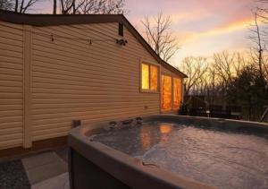 a hot tub in the backyard of a house at Pocono cabin with hot tub and private pool at Shawnee Mtn in East Stroudsburg