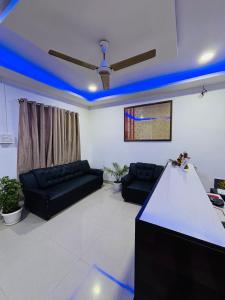 a living room with blue lights on the ceiling at Victus Emporium in Guwahati