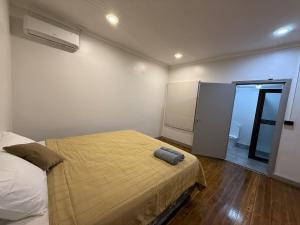 a bedroom with a bed with a yellow blanket on it at City Circle in Suva