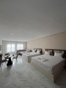a large room with two beds and a couch at Facelift in Tangier