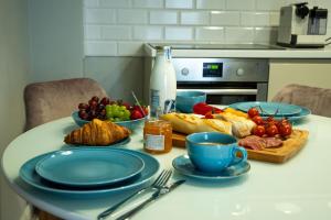 a table with plates and bowls of food on it at Apartament w Kościerzynie in Kościerzyna +8 photos
