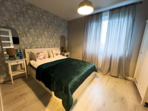 Una cama o camas en una habitación de Apartament w Kościerzynie
