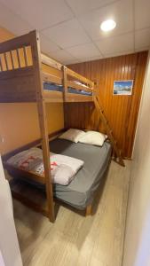 a bedroom with two bunk beds in a boat at Les cascades in Le Mont-Dore