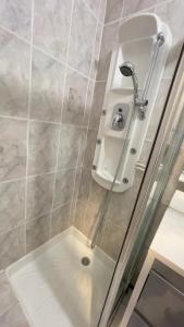 a shower with a glass door and a shower head at Les cascades in Le Mont-Dore +102 photos