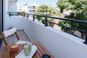 a balcony with a table and vases on it at Paizan Homes - Kos City Center Apartments in Kos