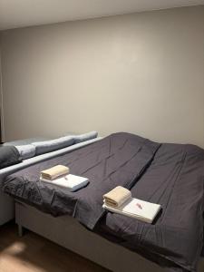 a bed with two books on top of it at Stylish and cozy apartment in Rovaniemi
